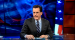Stephen Colbert framed by Statue of Liberty