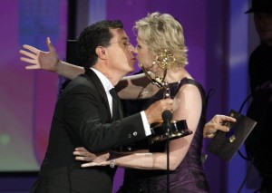 Stephen Colbert kisses Jane Lynch as she accepts the award for best supporting actress at the 62nd annual Primetime Emmy Awards in Los Angeles
