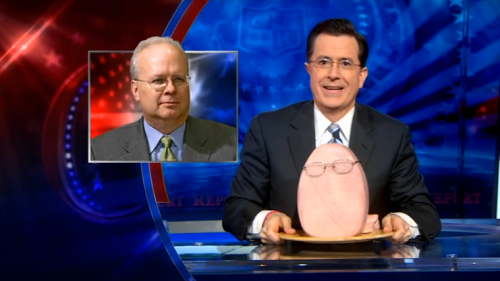 Stephen Colbert and a ham dressed up to be Karl Rove